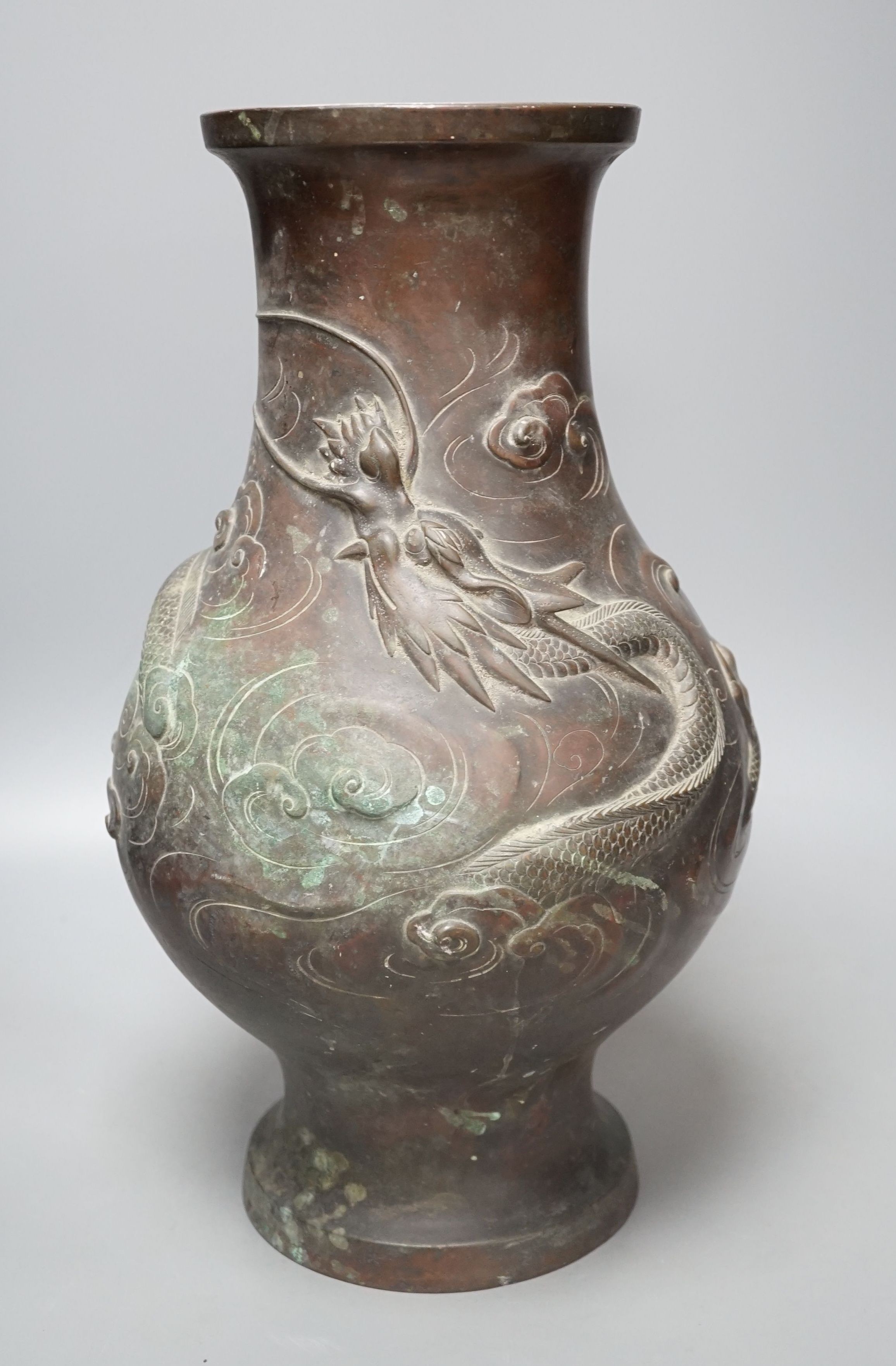 A large 19th century Japanese bronze dragon designed vase, 40cms high.